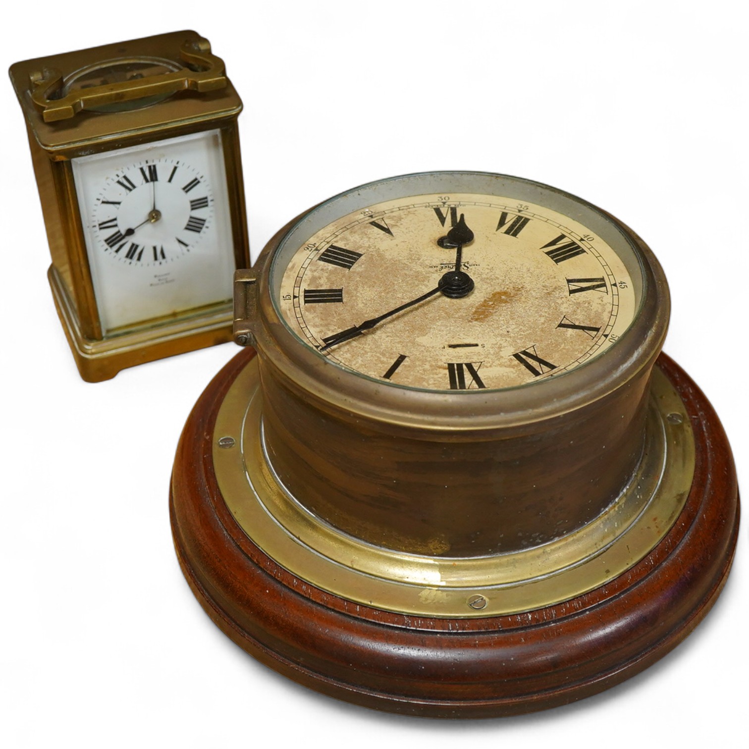 A brass bulk head timepiece and a late 19th century brass cased carriage clock, the dial inscribed Mallory Bath, made in Paris, with key